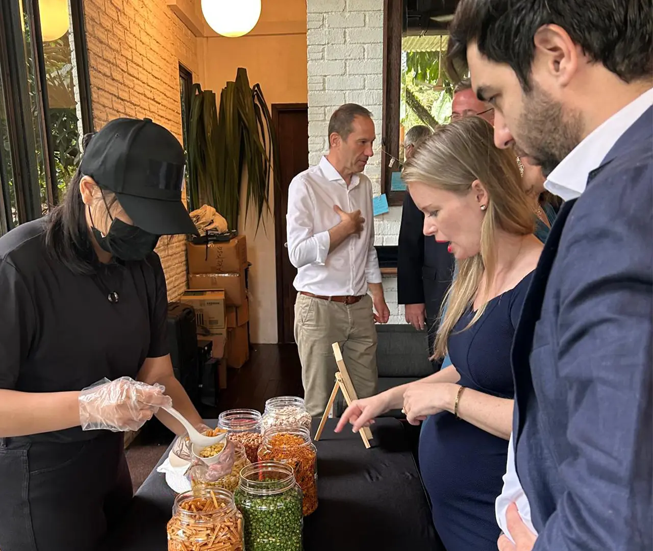 Catering setup with snacks in jars, team selecting items